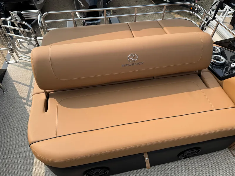 Slide: The Image of 2025 Regency 230 LE3 Sport boat with tan seating and sleek design. - 13