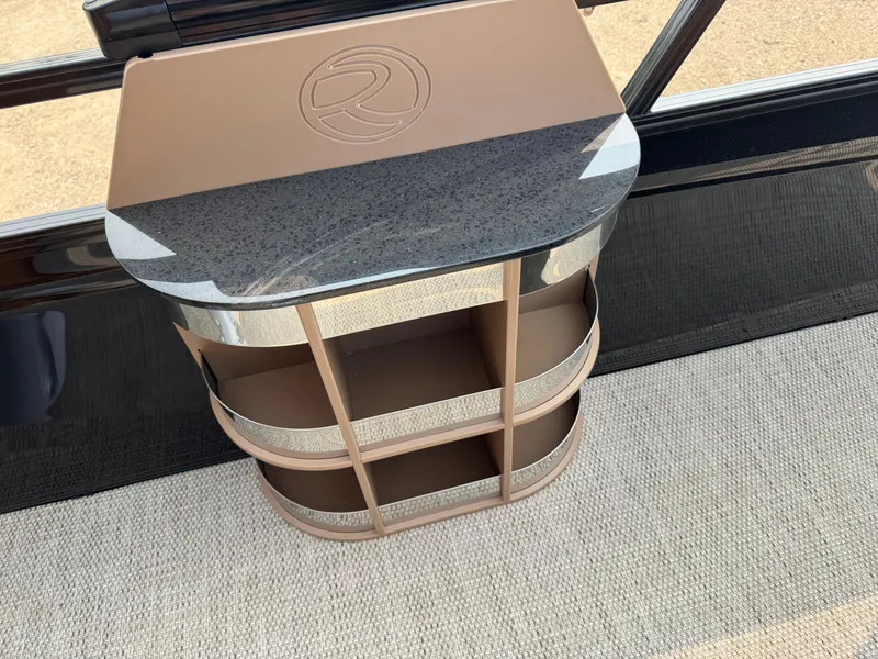 Slide: The Image of 2025 Regency 230 LE3 Sport boat with tan leather seating and stainless steel railing. - 14