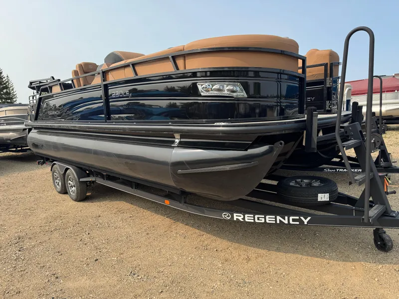 Slide: The Image of 2025 Regency 230 LE3 Sport pontoon boat in a warehouse setting. - 2