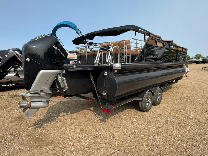 Slide: The Image of 2025 Regency 230 LE3 Sport pontoon boat with Mercury outboard in a warehouse setting. - 3