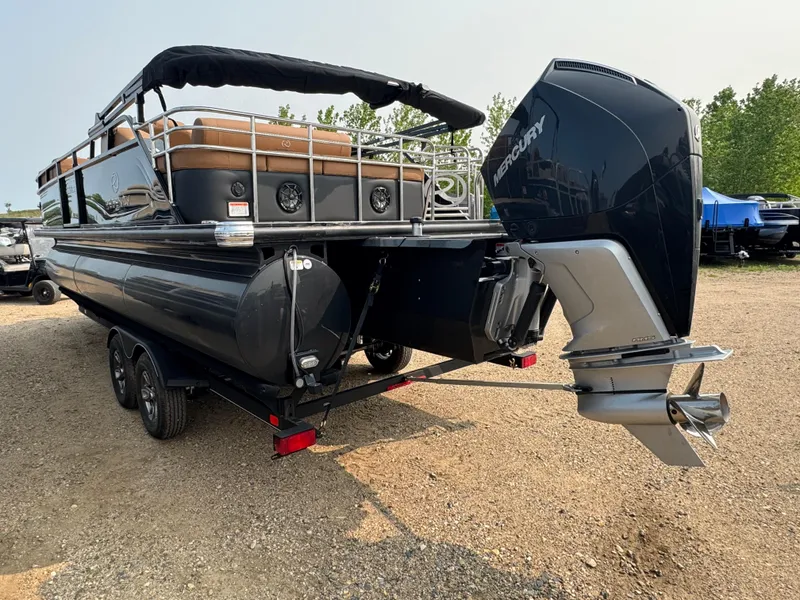 Slide: The Image of 2025 Regency 230 LE3 Sport pontoon boat with Mercury outboard motor in a garage. - 4