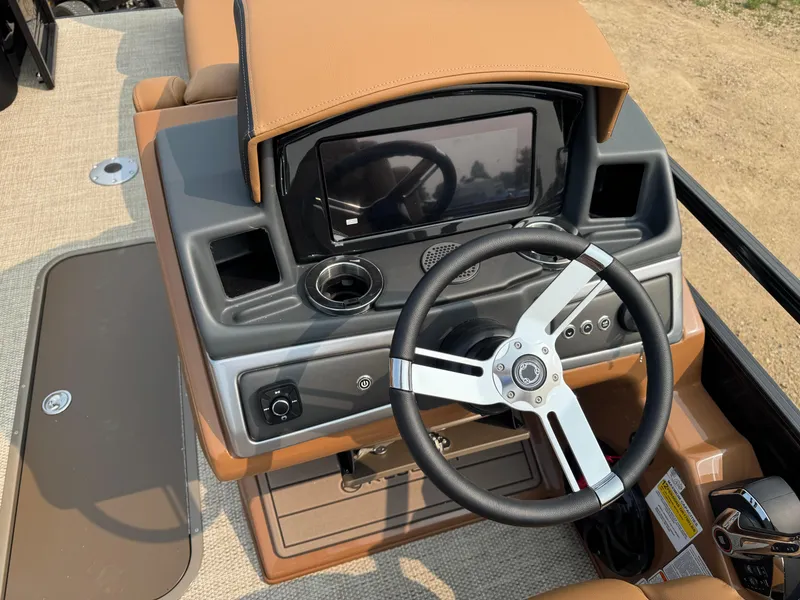 Slide: The Image of Captain's chair and steering wheel of 2025 Regency 230 LE3 Sport boat interior. - 9