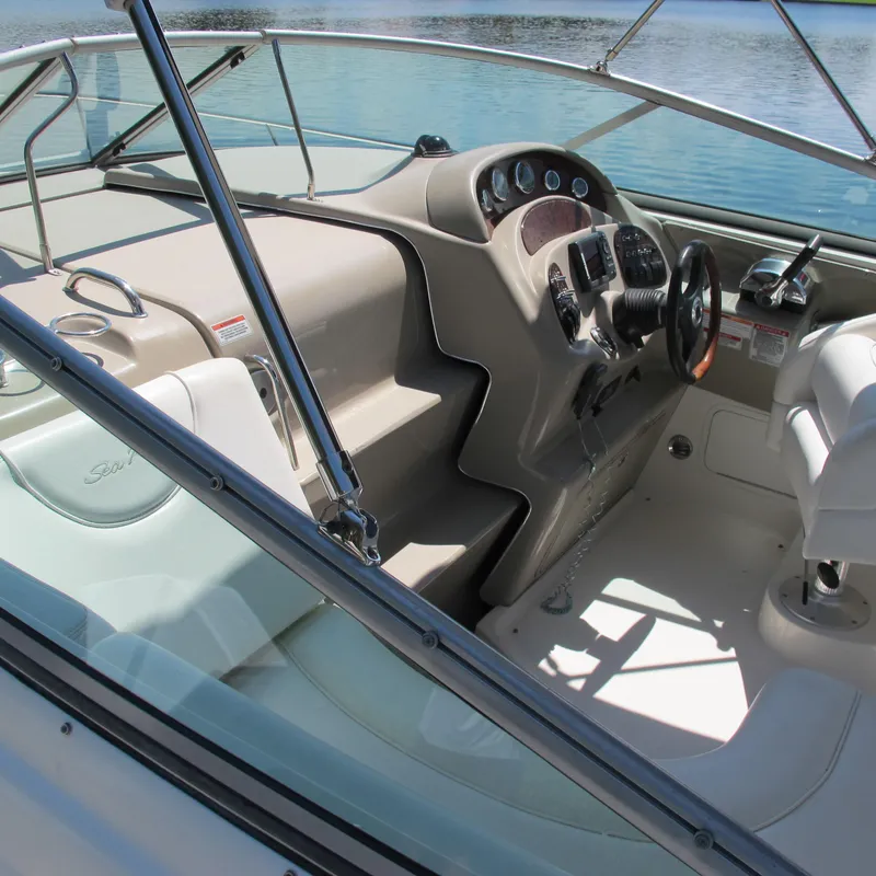 Slide: The Image of 2007 Sea Ray 280 DA boat cockpit with steering wheel and dashboard controls. - 12