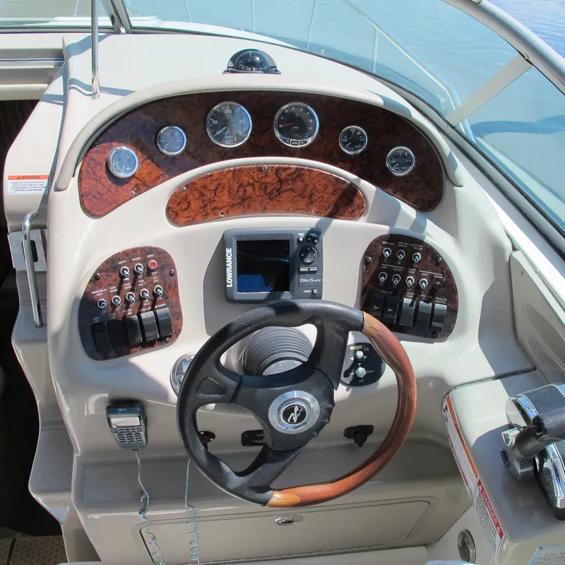 Slide: The Image of 2007 Sea Ray 280 DA boat dashboard with steering wheel and control panel. - 14
