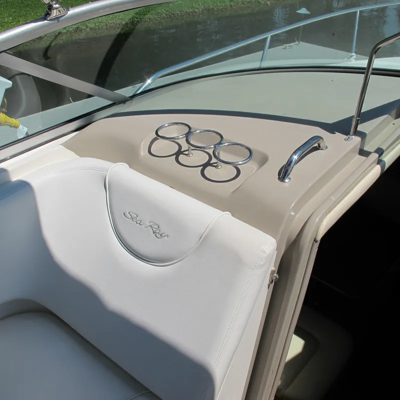 Slide: The Image of 2007 Sea Ray 280 DA boat interior with cup holders and white seating. - 17