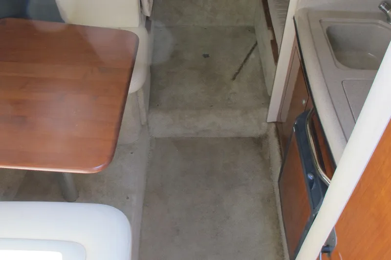 Slide: The Image of 2007 Sea Ray 280 DA cabin interior with table, seating, and kitchenette. - 20