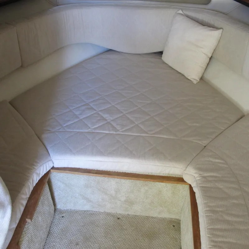 Slide: The Image of 2007 Sea Ray 280 DA cabin interior with cushioned seating and pillow. - 25