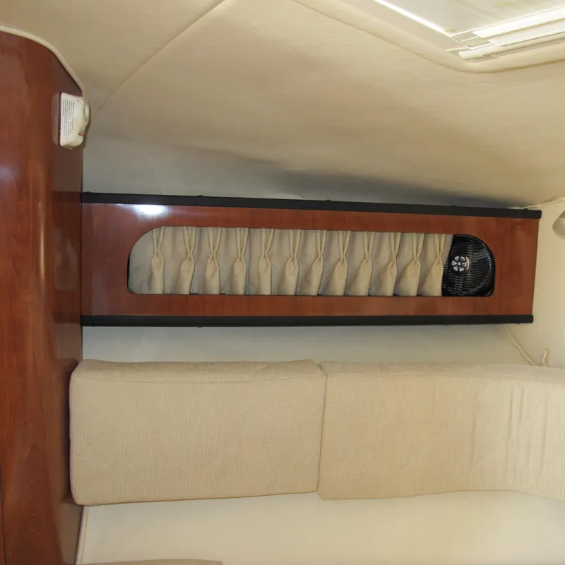 Slide: The Image of Interior cabin of 2007 Sea Ray 280 DA with beige seating and wood paneling. - 26