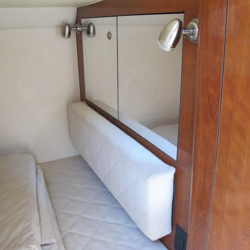 Slide: The Image of Interior cabin of 2007 Sea Ray 280 DA with wood paneling and cushioned seating. - 28