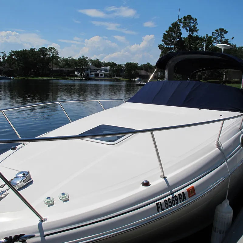 Slide: The Image of 2007 Sea Ray 280 DA boat docked on a calm lake under a clear sky. - 3
