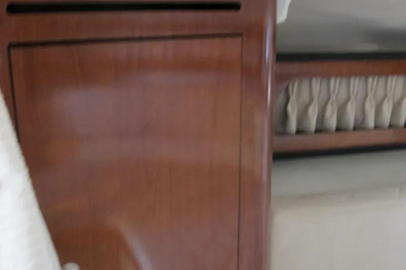 Slide: The Image of Interior of 2007 Sea Ray 280 DA boat with wooden cabinetry and seating area. - 30