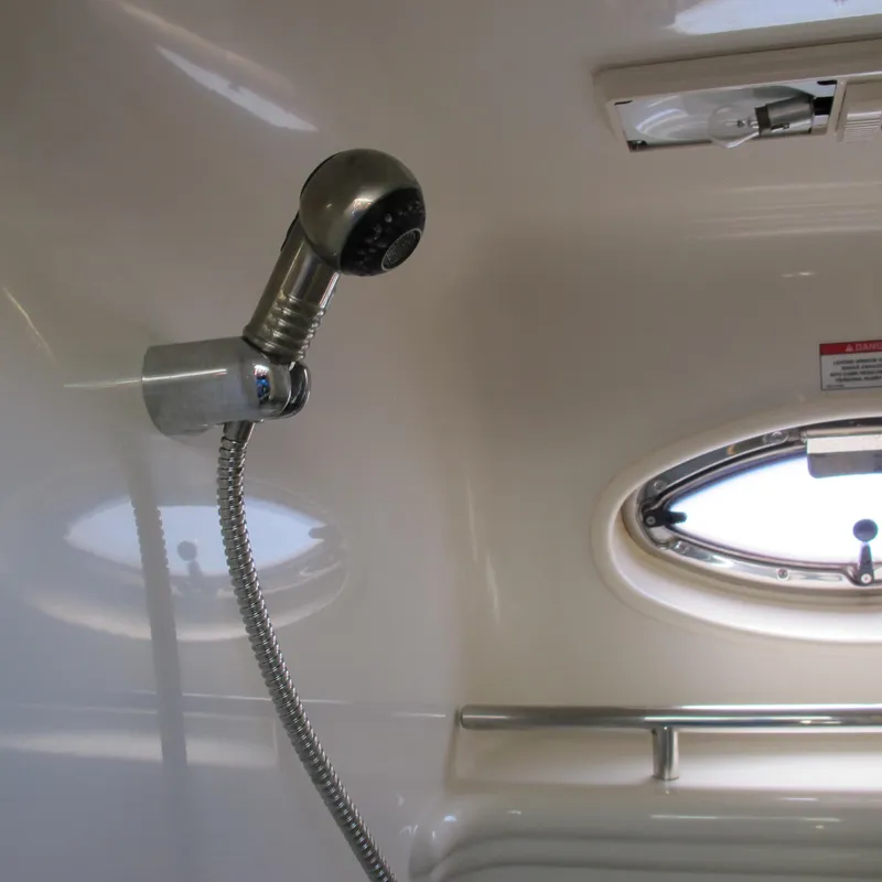 Slide: The Image of Interior shower area of 2007 Sea Ray 280 DA boat with porthole and showerhead. - 34