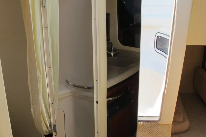 Slide: The Image of 2007 Sea Ray 280 DA boat interior with compact bathroom and sink. - 36