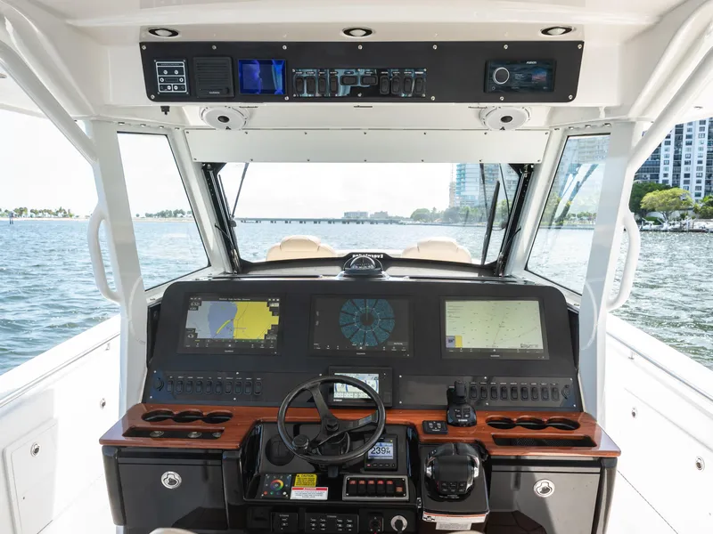 Slide: The Image of 2020 Everglades 435 Center Console boat dashboard with navigation screens and controls. - 14