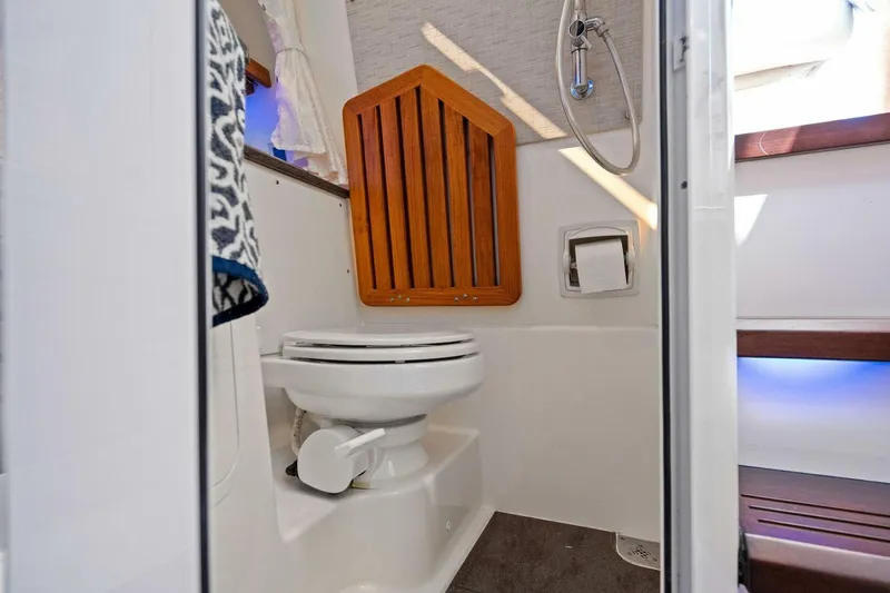 Slide: The Image of 2019 Boston Whaler 350 Realm boat bathroom interior with toilet and shower. - 11