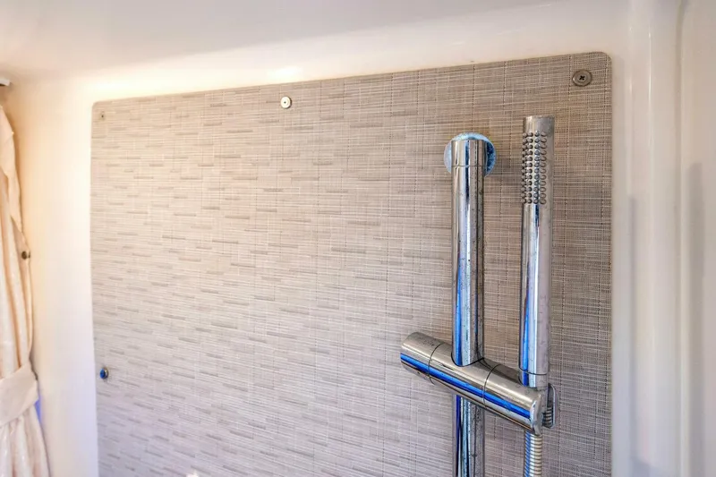 Slide: The Image of Shower area in 2019 Boston Whaler 350 Realm boat, featuring modern chrome fixtures. - 12