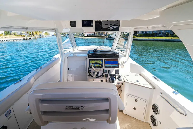 Slide: The Image of 2019 Boston Whaler 350 Realm cockpit with advanced navigation system on a sunny day. - 16