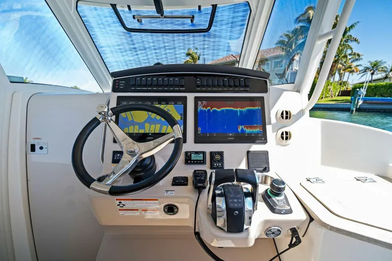Slide: The Image of 2019 Boston Whaler 350 Realm helm with advanced navigation displays and controls. - 17