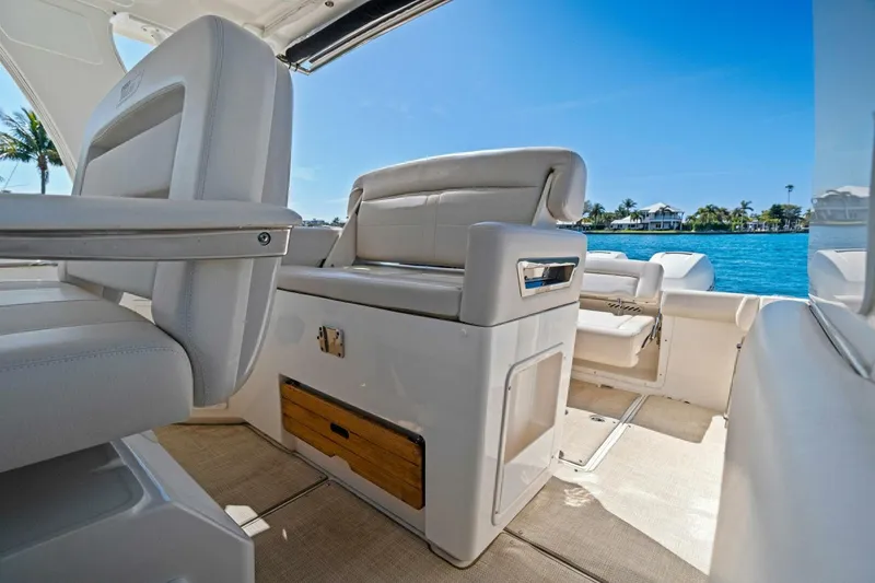 Slide: The Image of 2019 Boston Whaler 350 Realm interior with luxurious seating and ocean view. - 20