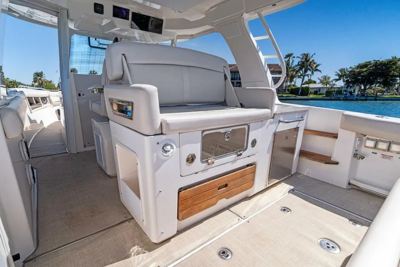 Slide: The Image of 2019 Boston Whaler 350 Realm interior, featuring luxurious seating and modern amenities by the water. - 21