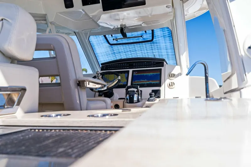 Slide: The Image of 2019 Boston Whaler 350 Realm cockpit with advanced navigation systems and luxurious seating. - 25