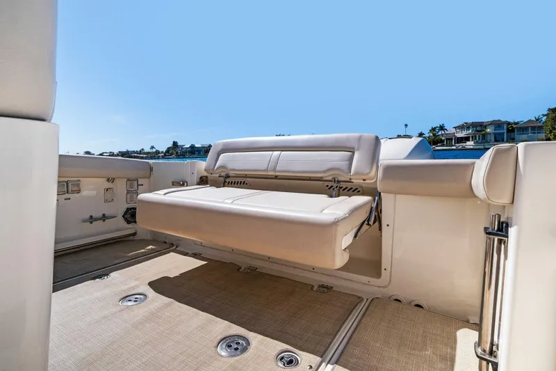 Slide: The Image of 2019 Boston Whaler 350 Realm boat with foldable seating, beige upholstery, and spacious deck. - 26