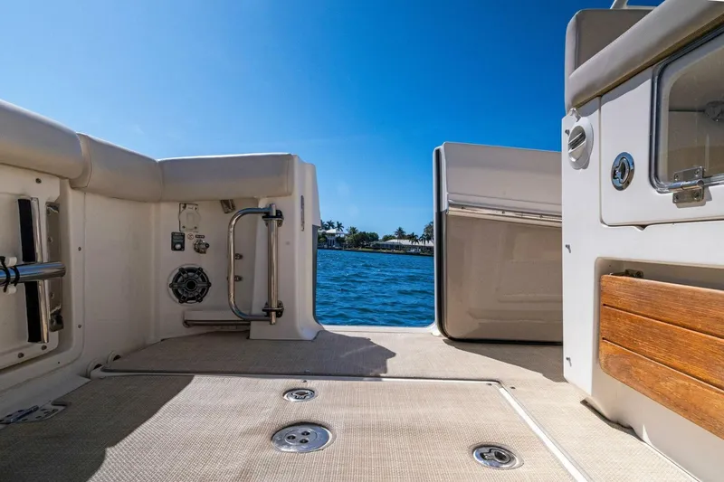 Slide: The Image of 2019 Boston Whaler 350 Realm boat deck with ocean view under clear blue sky. - 27