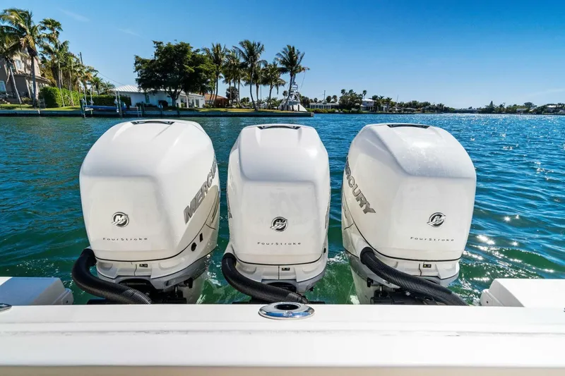 Slide: The Image of Triple Mercury outboard engines on a 2019 Boston Whaler 350 Realm, cruising in sunny waters. - 30