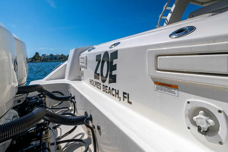 Slide: The Image of 2019 Boston Whaler 350 Realm boat docked at Holmes Beach, FL, under clear blue sky. - 31