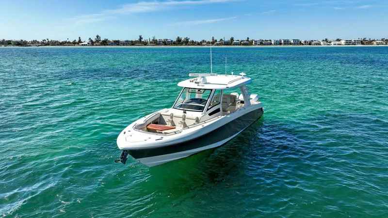 Slide: The Image of 2019 Boston Whaler 350 Realm boat on clear turquoise water. - 34