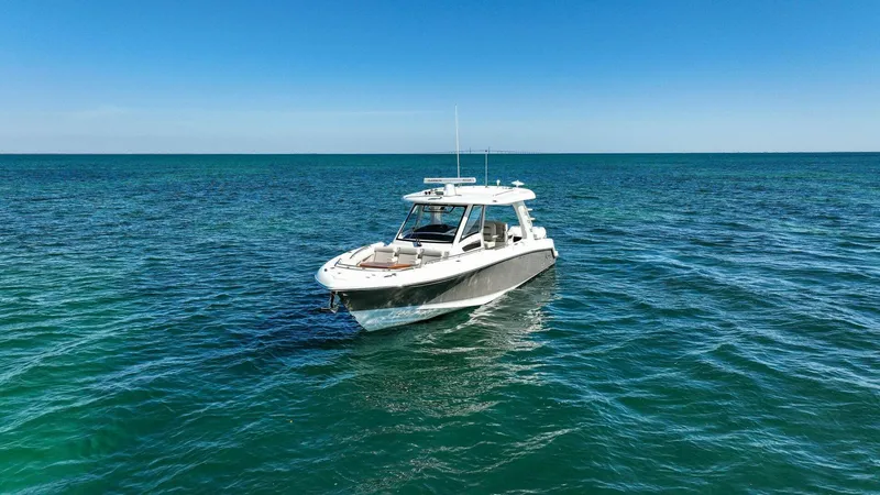 Slide: The Image of 2019 Boston Whaler 350 Realm boat cruising on open blue sea. - 35