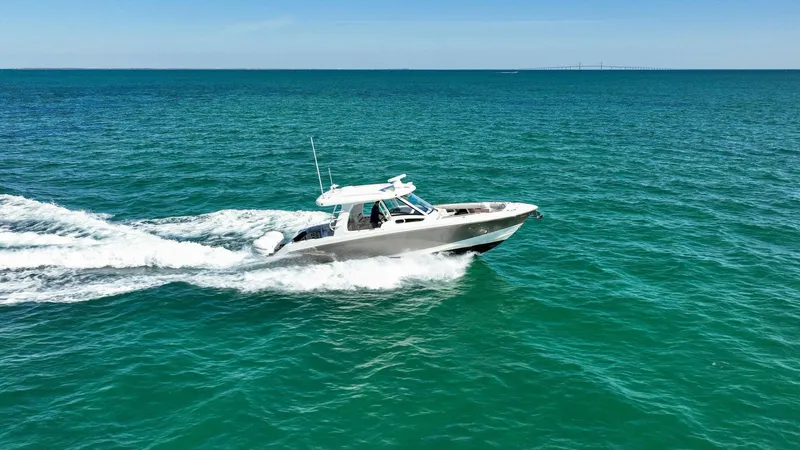 Slide: The Image of 2019 Boston Whaler 350 Realm cruising on open sea under clear blue sky. - 37