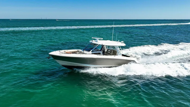 Slide: The Image of 2019 Boston Whaler 350 Realm cruising on clear blue ocean waters. - 38