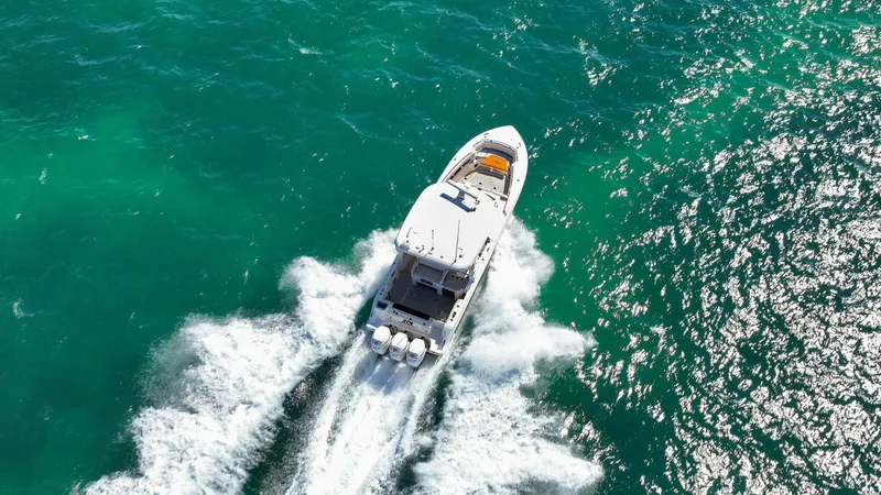Slide: The Image of Aerial view of 2019 Boston Whaler 350 Realm cruising on turquoise waters. - 39