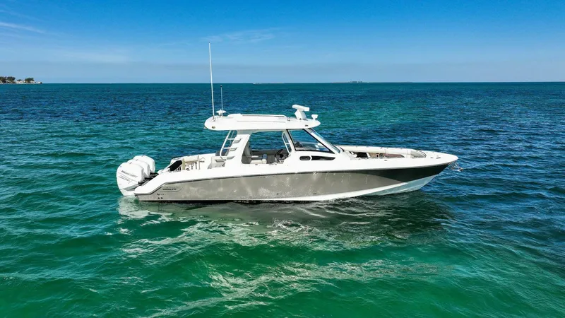 Slide: The Image of 2019 Boston Whaler 350 Realm boat on clear blue ocean water. - 42