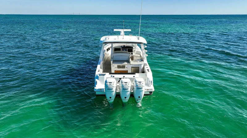 Slide: The Image of 2019 Boston Whaler 350 Realm boat on clear blue ocean water. - 43