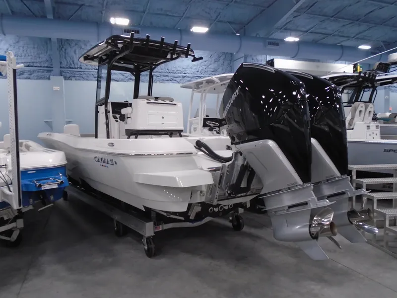 Slide: The Image of 2025 Caymas 281 HB boat with dual outboard engines in showroom. - 10