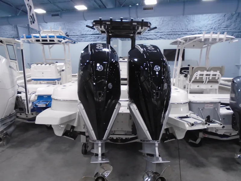 Slide: The Image of 2025 Caymas 281 HB boat with dual outboard engines in showroom. - 11