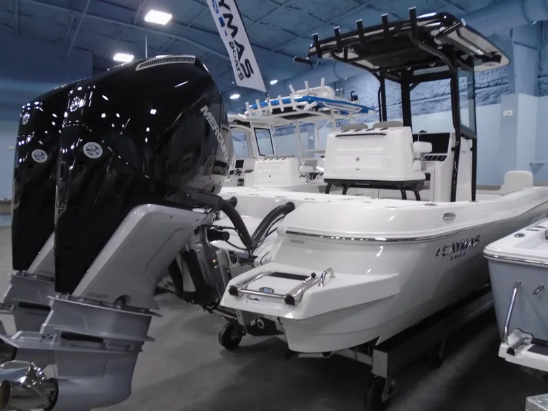 Slide: The Image of 2025 Caymas 281 HB boat with dual engines displayed indoors. - 12