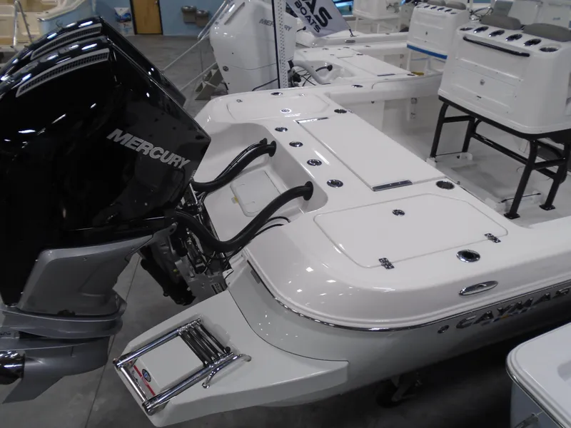 Slide: The Image of 2025 Caymas 281 HB boat with Mercury engine, displayed indoors. - 13
