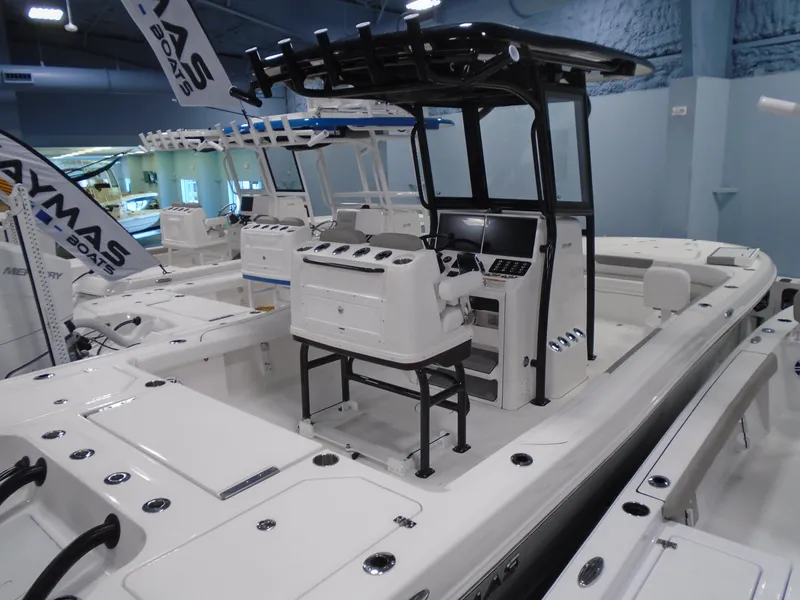 Slide: The Image of 2025 Caymas 281 HB boat displayed indoors, featuring sleek design and modern console. - 14