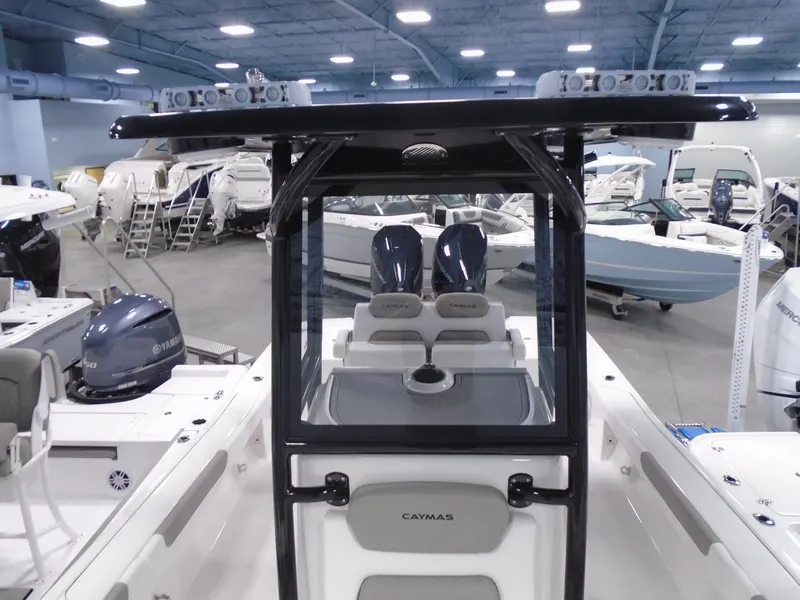Slide: The Image of 2025 Caymas 281 HB boat interior with dual engines in a showroom. - 17