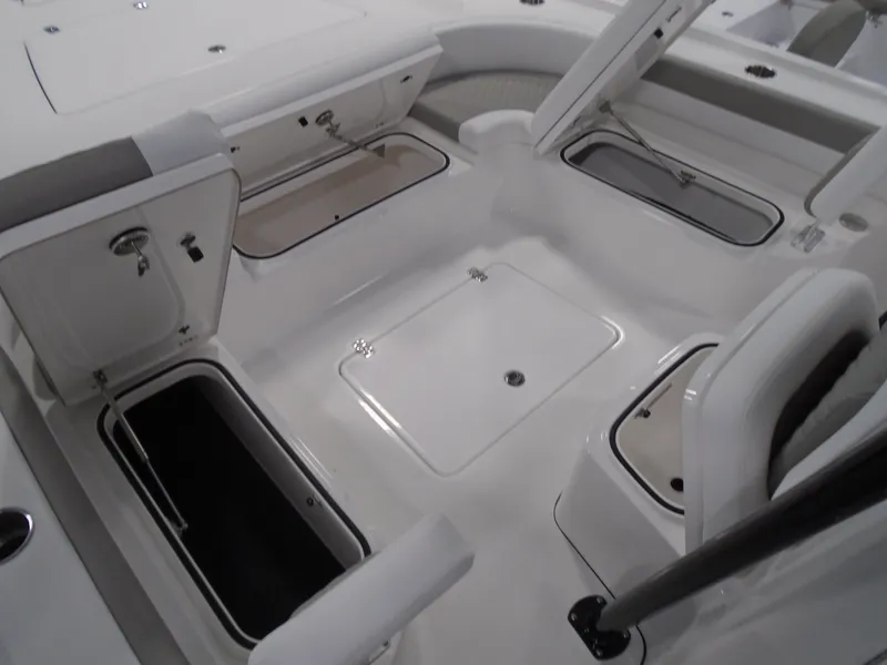 Slide: The Image of 2025 Caymas 281 HB boat interior with open storage compartments and seating. - 18