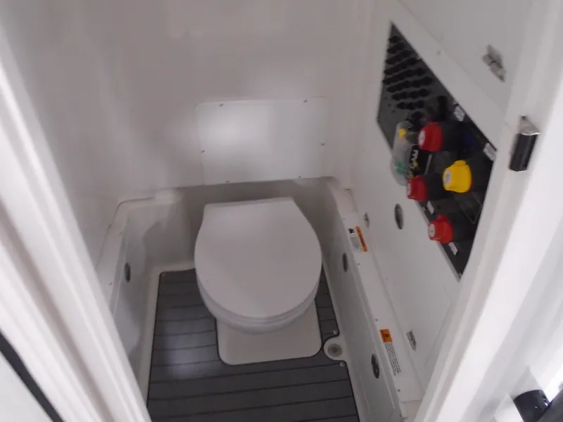 Slide: The Image of 2025 Caymas 281 HB boat interior with compact marine toilet and control panel. - 19