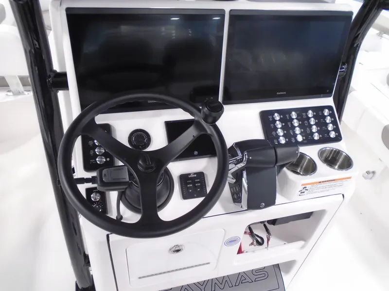 Slide: The Image of 2025 Caymas 281 HB boat dashboard with dual screens and control panel. - 21