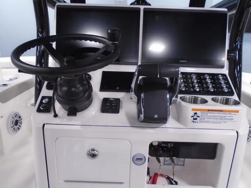 Slide: The Image of 2025 Caymas 281 HB boat dashboard with dual screens and steering wheel. - 22