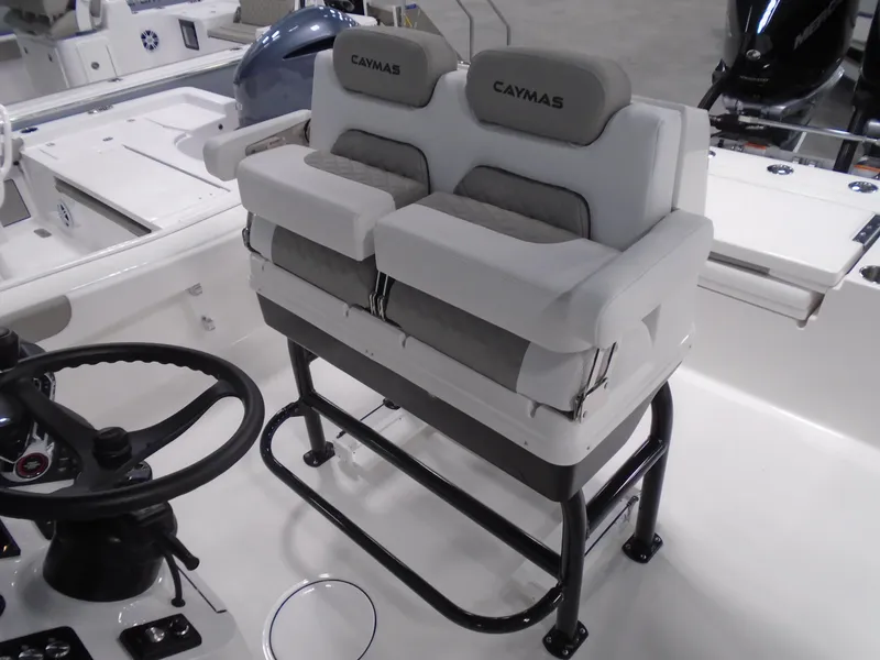 Slide: The Image of 2025 Caymas 281 HB boat interior with dual cushioned seats and steering wheel. - 23