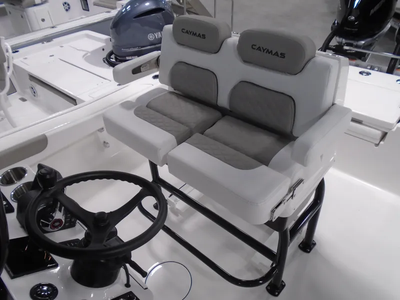 Slide: The Image of 2025 Caymas 281 HB boat interior with dual seating and steering wheel. - 24