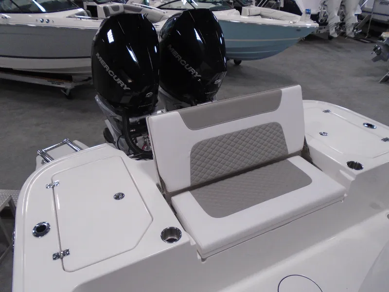 Slide: The Image of 2025 Caymas 281 HB boat with dual Mercury engines and cushioned seating. - 27