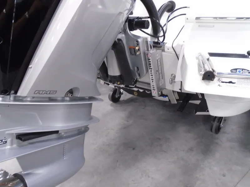 Slide: The Image of 2025 Caymas 281 HB boat engine and transom detail in a showroom. - 30